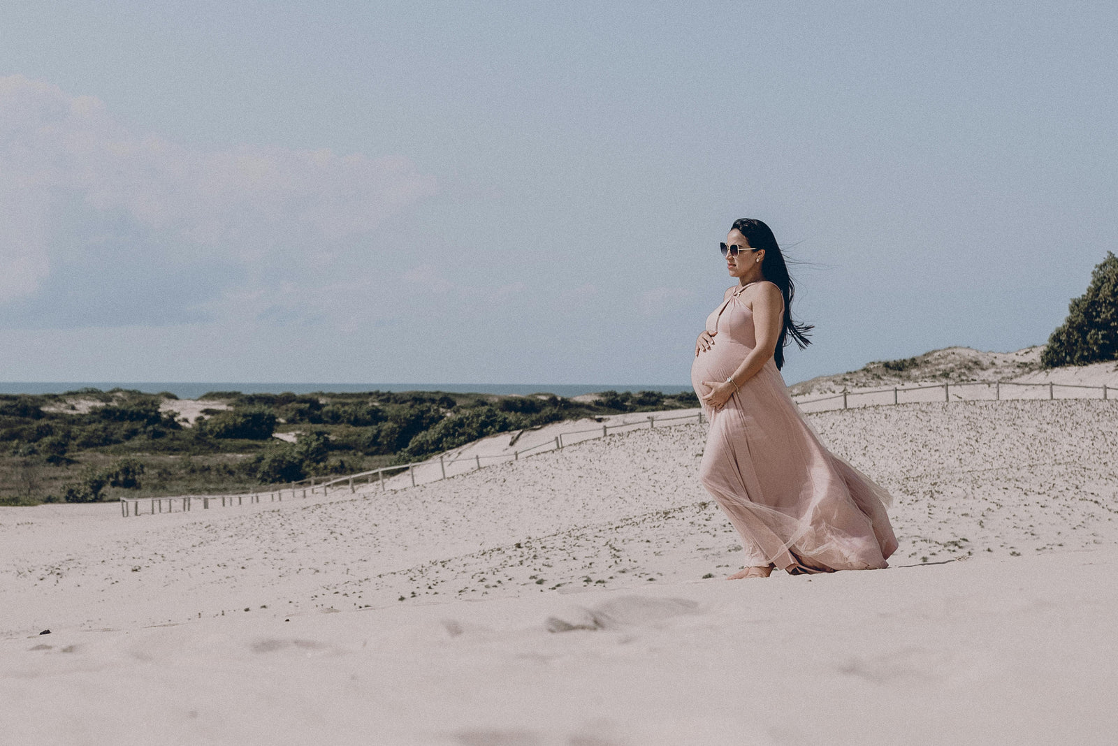 pregnant women walking on sands