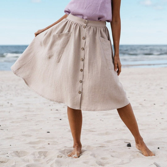 Women wears linen buttoned front skirt in natural color