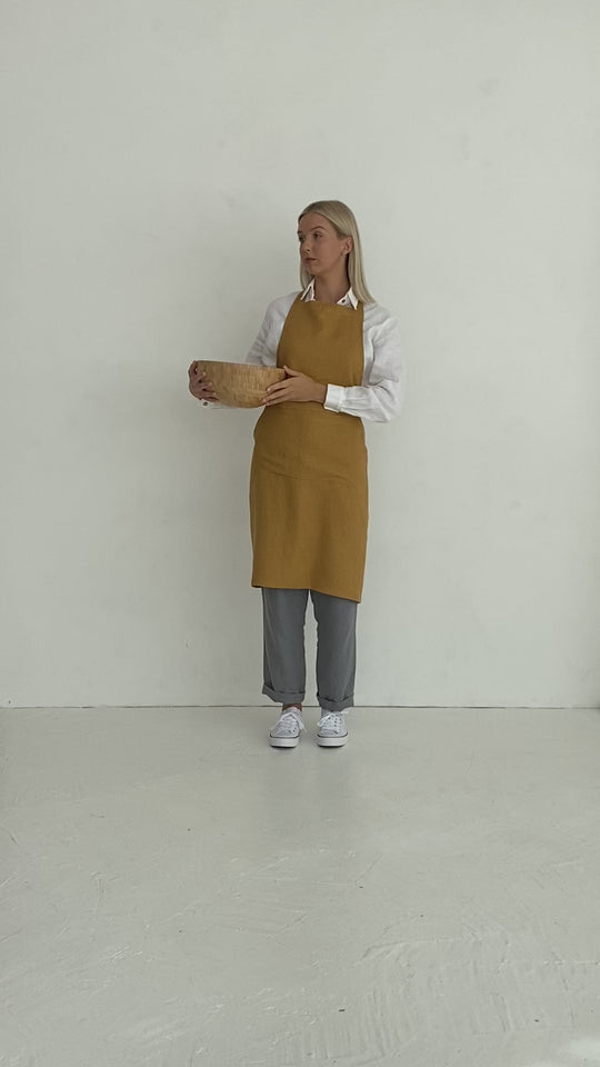 Model Wears Linen Bib Apron In Amber Yellow Color