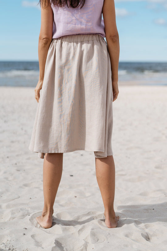 Women shows back of linen skirt