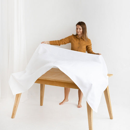 Women Serves Table With Linen Tablecloth In White Color - Daily Linen