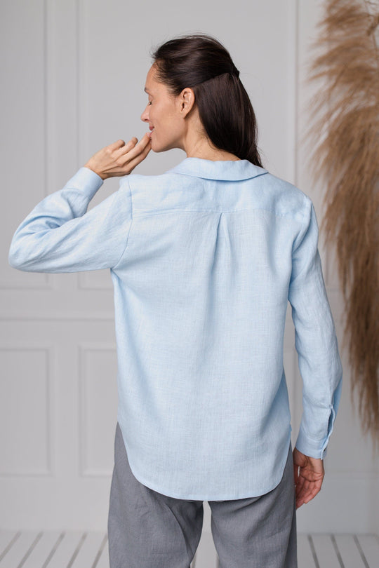 Women wears button front linen shirt in blue color