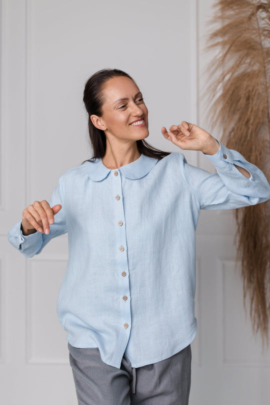 Women wears button front linen shirt in blue color