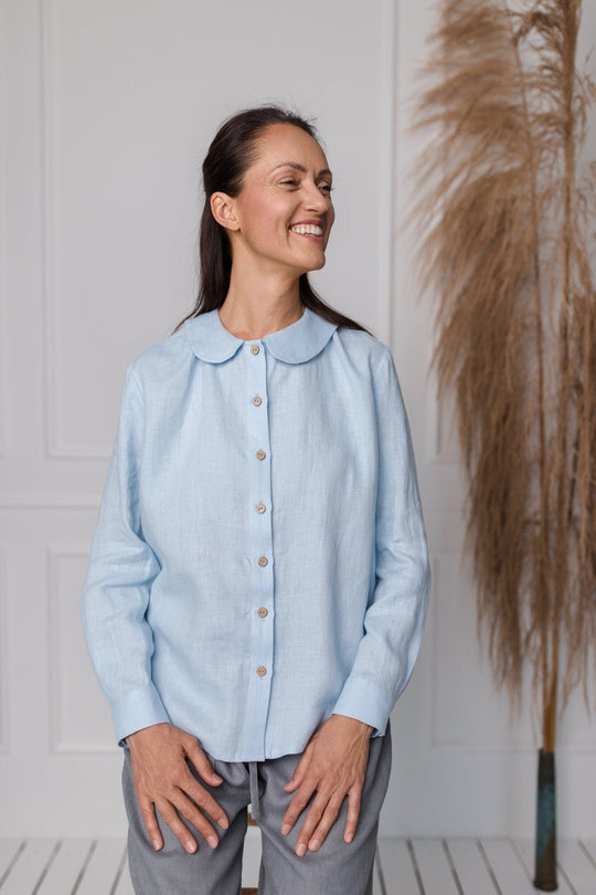 Women wears button front linen shirt in blue color