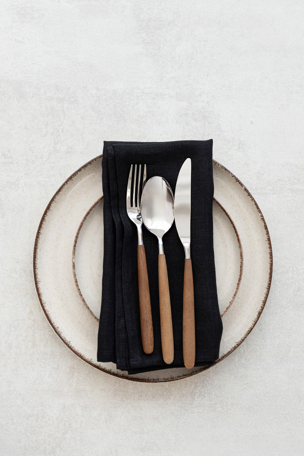Black linen napkins served with fork and knife
