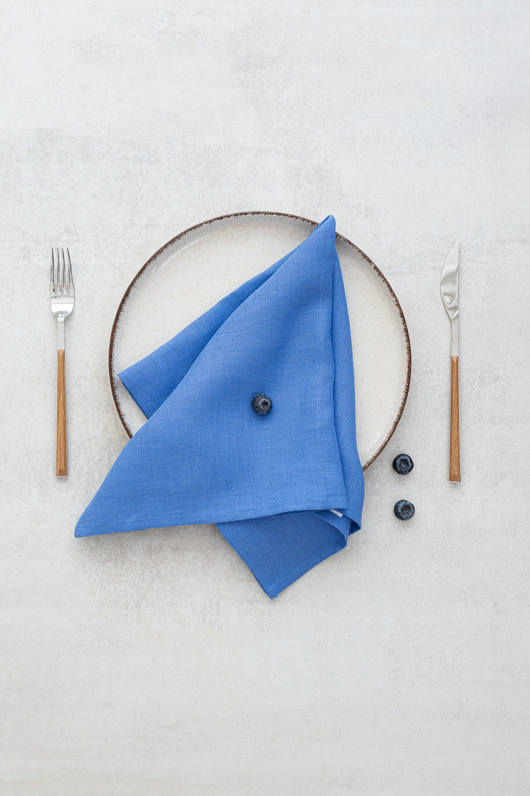Blue linen napkins with bilberries