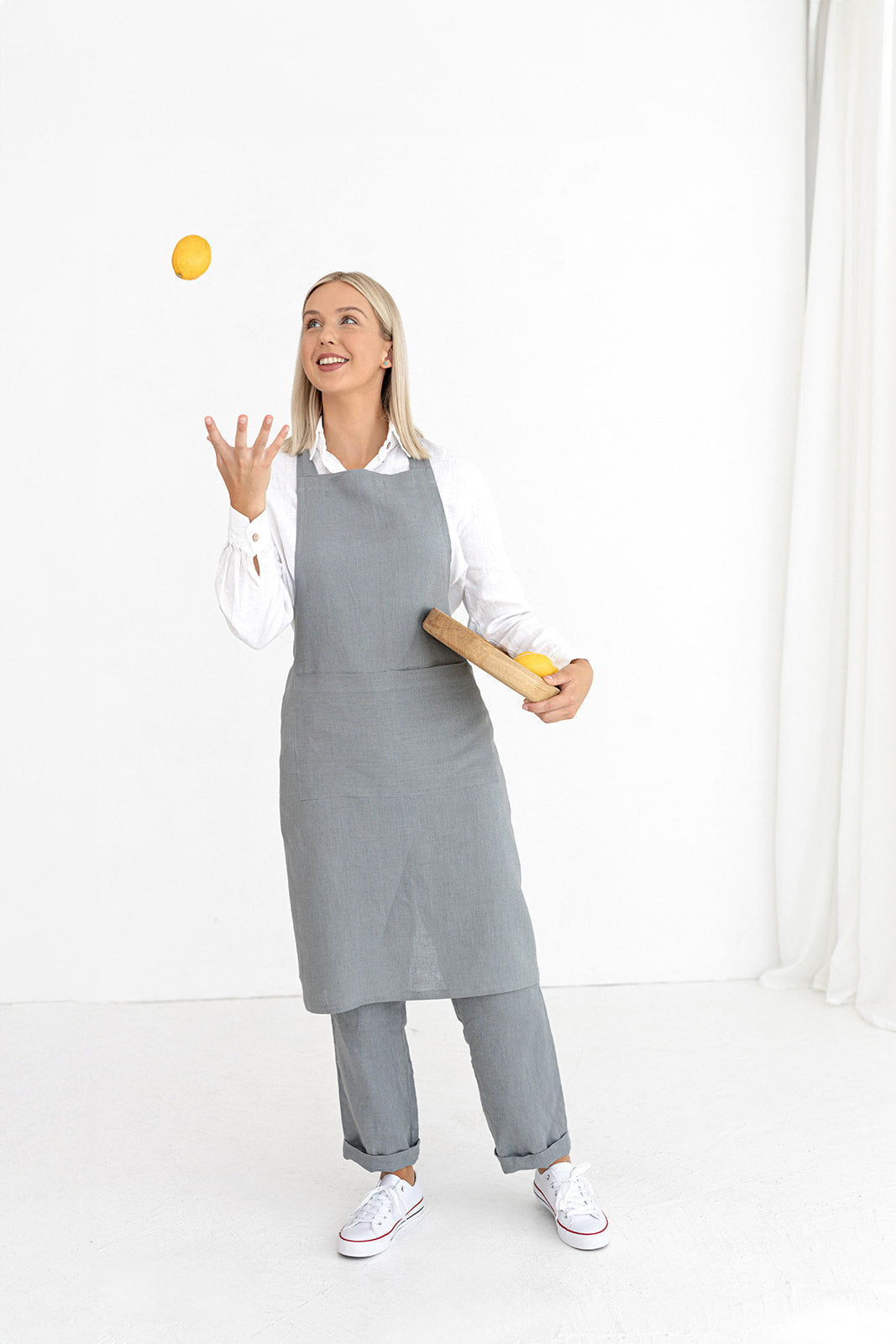 Model Wears Linen Bib Apron In Grey Made By Daily Linen