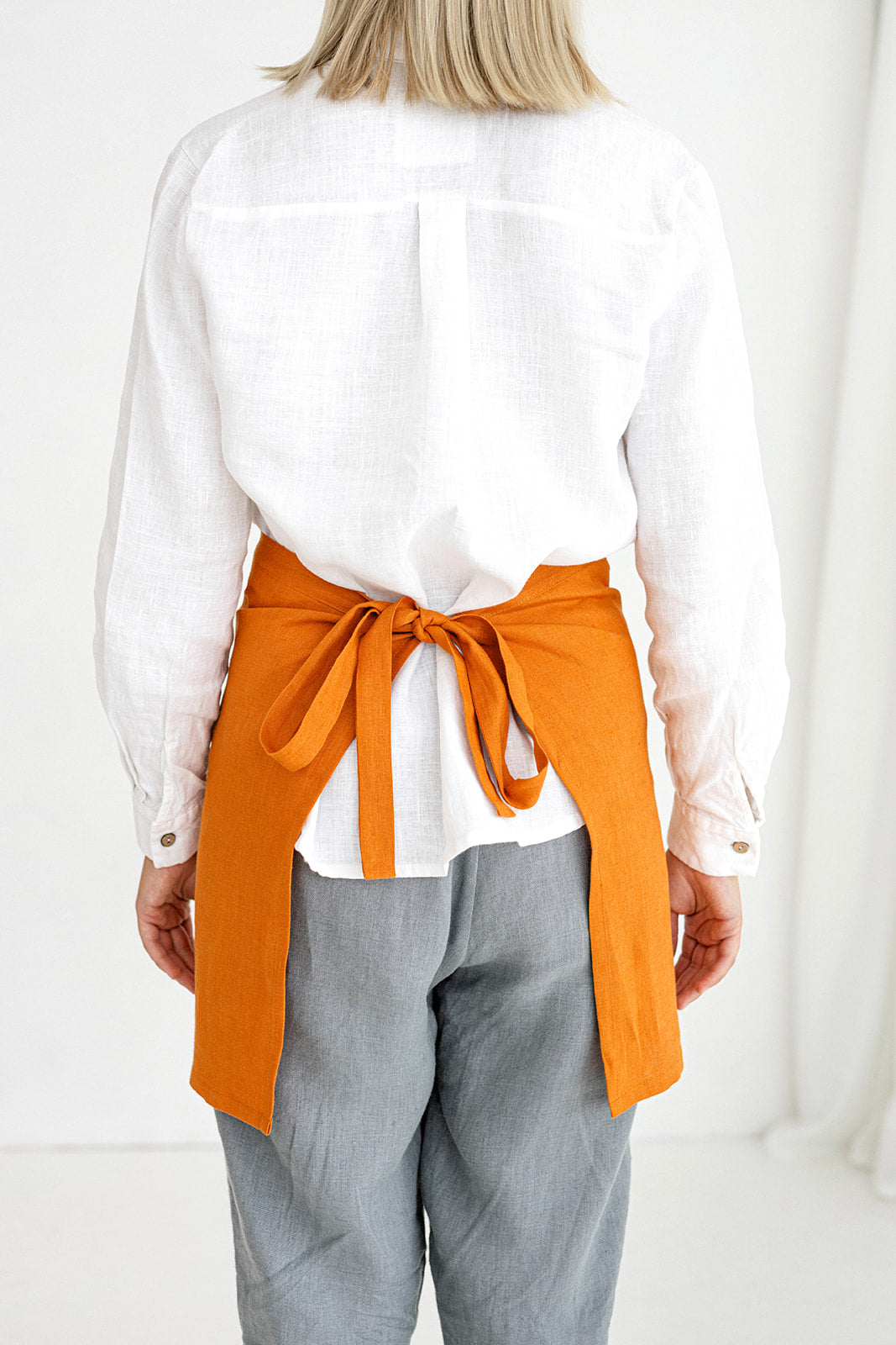 Model Demonstrates Linen Half Apron In Mustard Color Made By Daily Linen 2