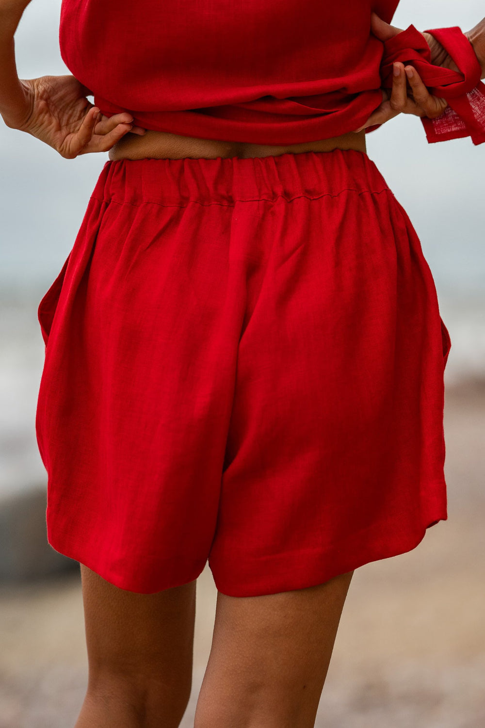 Model Demonstrates Linen Shorts Ashley In Red Color From Back