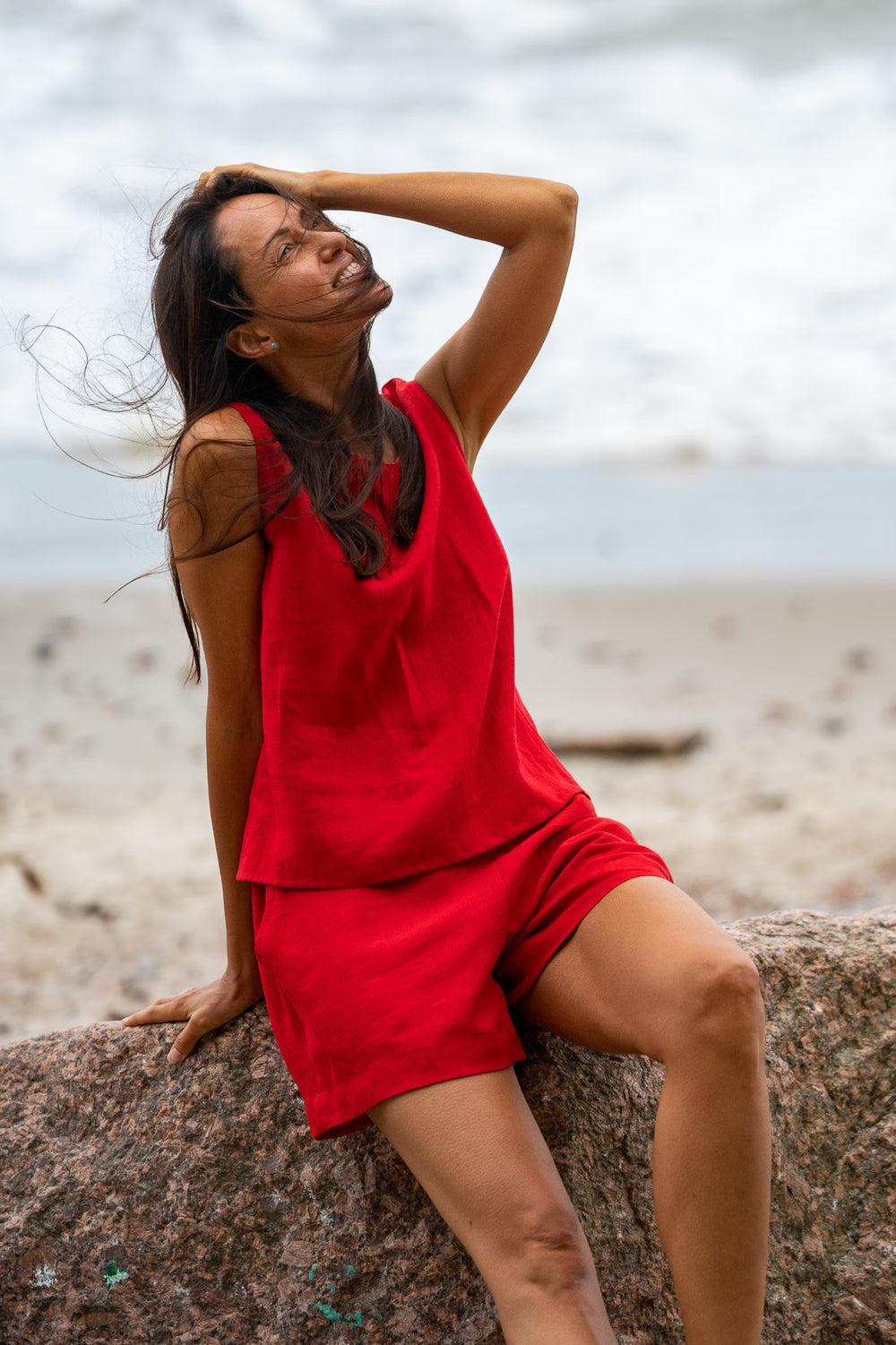 Model In Beach Demonstrates Linen Tank Top Teide In Red Color 1 - Daily Linen