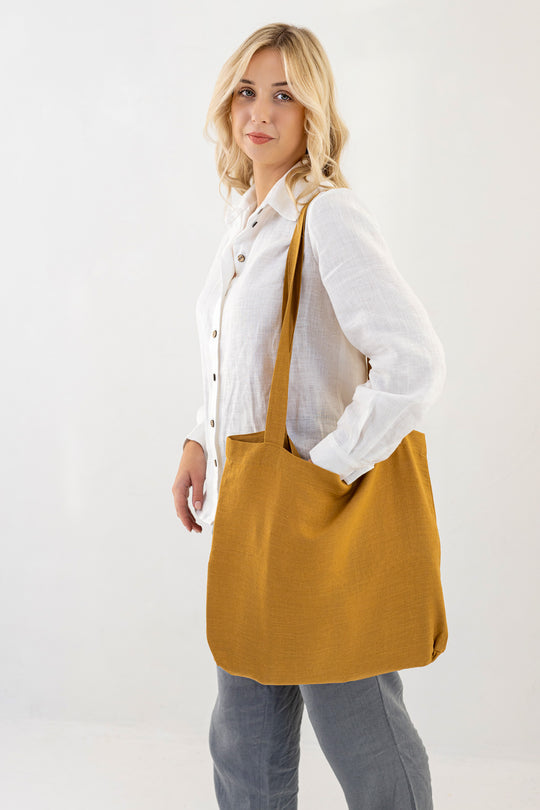 Model Demonstrates Daily Linen Tote Bag In Amber Yellow Color 1