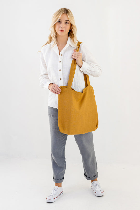 Model Demonstrates Daily Linen Tote Bag In Amber Yellow Color 2