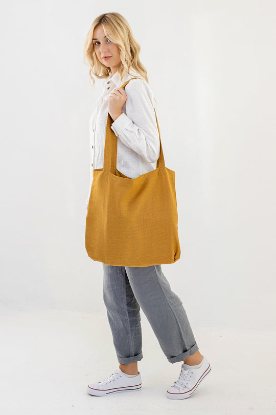 Model Demonstrates Daily Linen Tote Bag In Amber Yellow Color 3