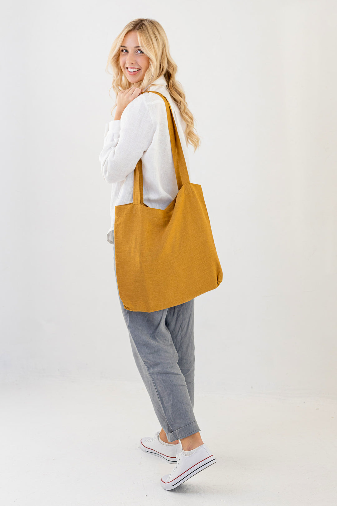 Model Demonstrates Daily Linen Tote Bag In Amber Yellow Color 4