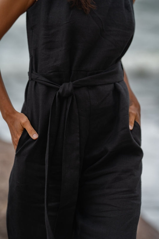 Model In Beach Demonstrates Linen Wrap Junpsuit Dicey In Black Color 3 - Daily Linen