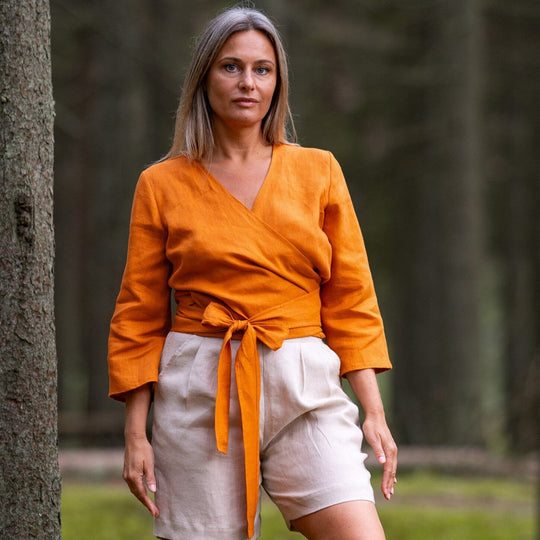 Women In Forest Demonstrates Linen Wrap Top Madeira In Mustard Color - Daily Linen