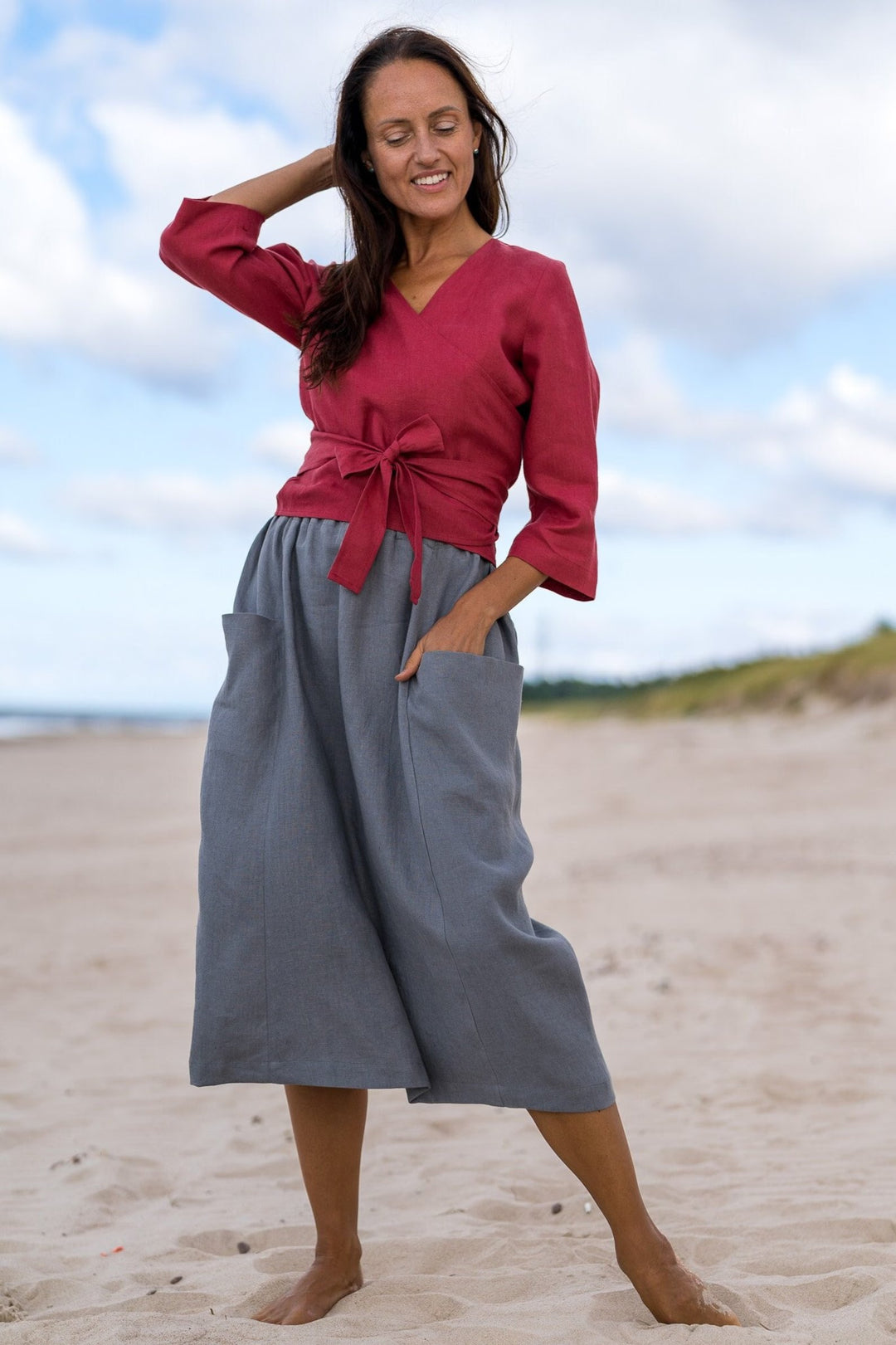 Model In Beach Demonstrates Linen Wrap Top Madeira In Raspberry Color 1 - Daily Linen