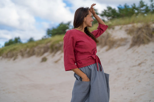 Model In Beach Demonstrates Linen Wrap Top Madeira In Raspberry Color 2 - Daily Linen