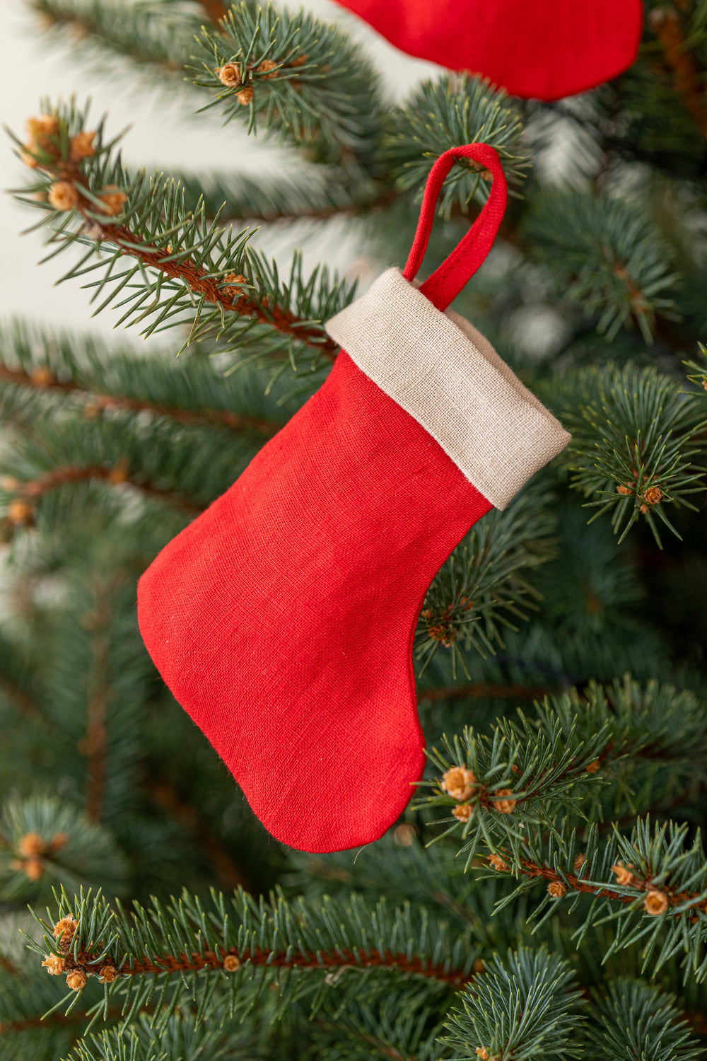 Linen Christmas Stocking In Red Color Hanging On Tree - Daily Linen