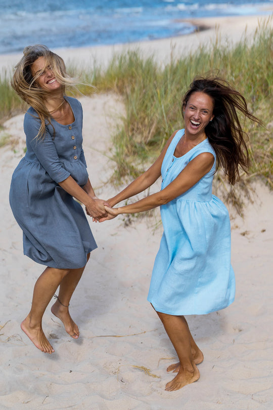 2 Models In Beach Demonstrates Daily Linen Dresses By Dancing - Daily Linen