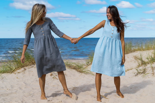 2 Models In Beach Demonstrates Daily Linen Dresses By Holding Each Other Hand - Daily Linen