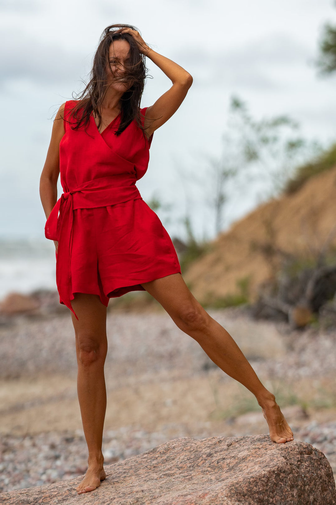 Model In Beach Demonstrates Sleeveless  Linen Wrap Top Julia In Red Color 4 - Daily Linen