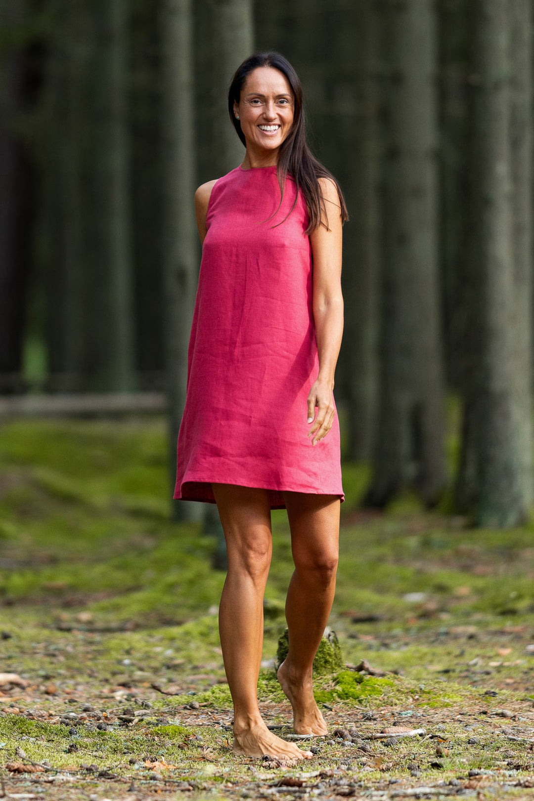 Model In Forest Demonstrates Linen Dress Victoria In Raspberry Color - Daily Linen