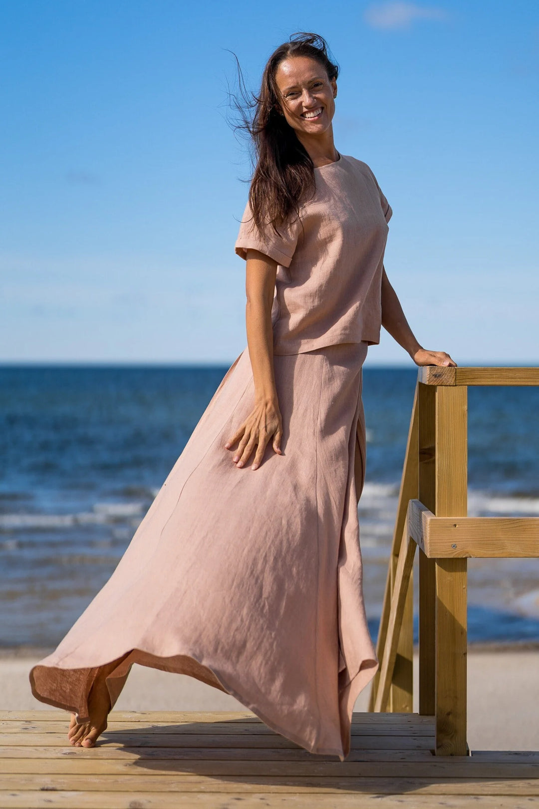 Model In Beach Demonstrates Linen Wrap Maxi Skirt In Powder Color - Daily Linen