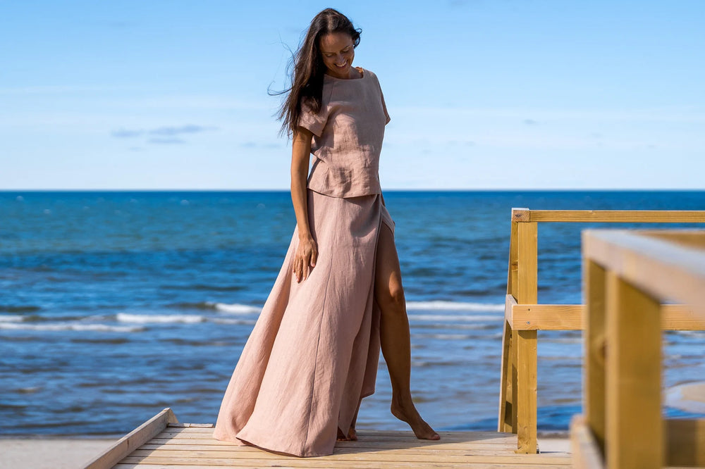 Model In Beach Demonstrates Linen Wrap Maxi Skirt In Powder Color 1 - Daily Linen