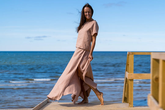 Model In Beach Demonstrates Linen Wrap Maxi Skirt In Powder Color 2 - Daily Linen