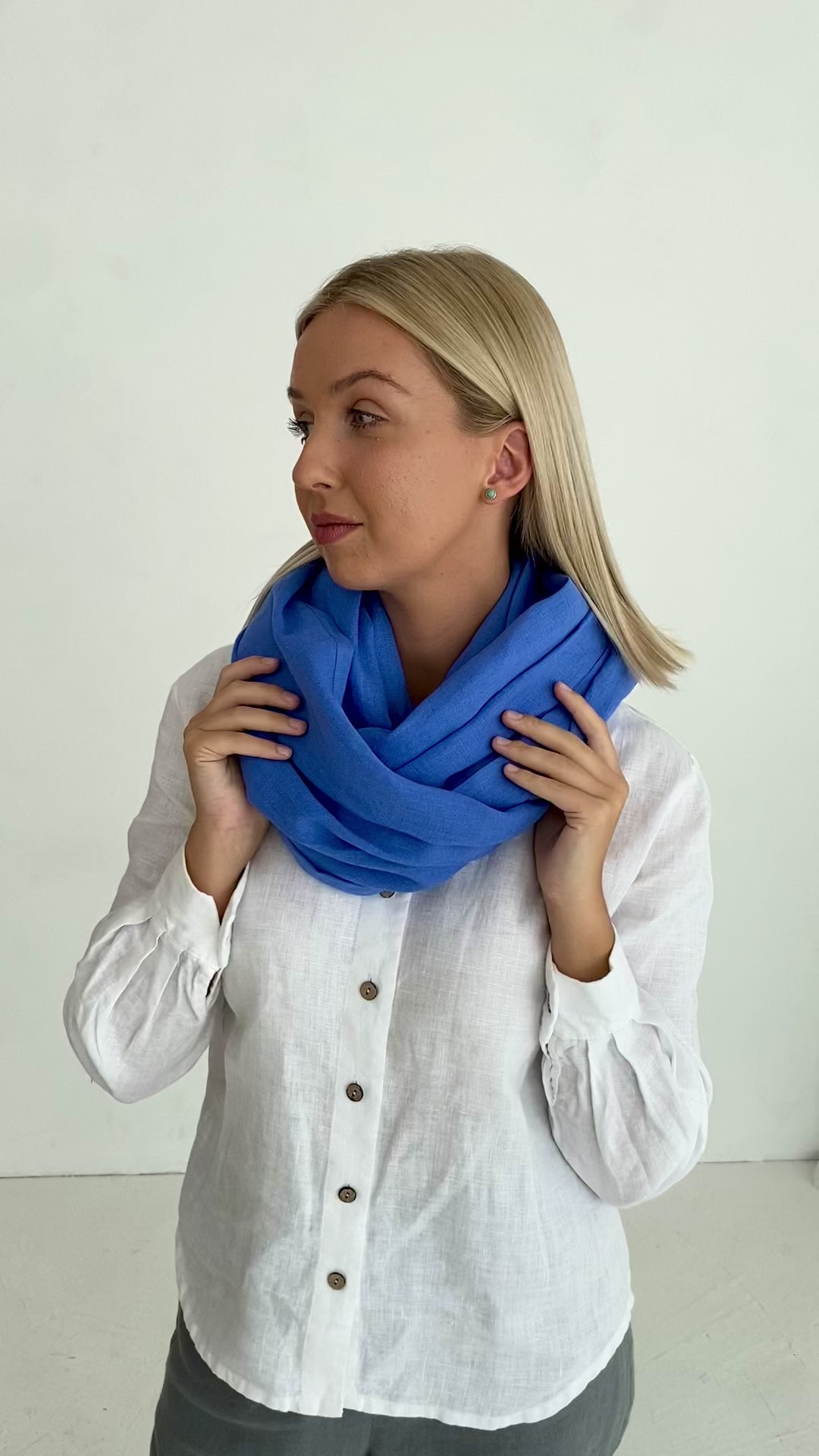 Model demonstrates linen blue scarf made by Daily Linen company