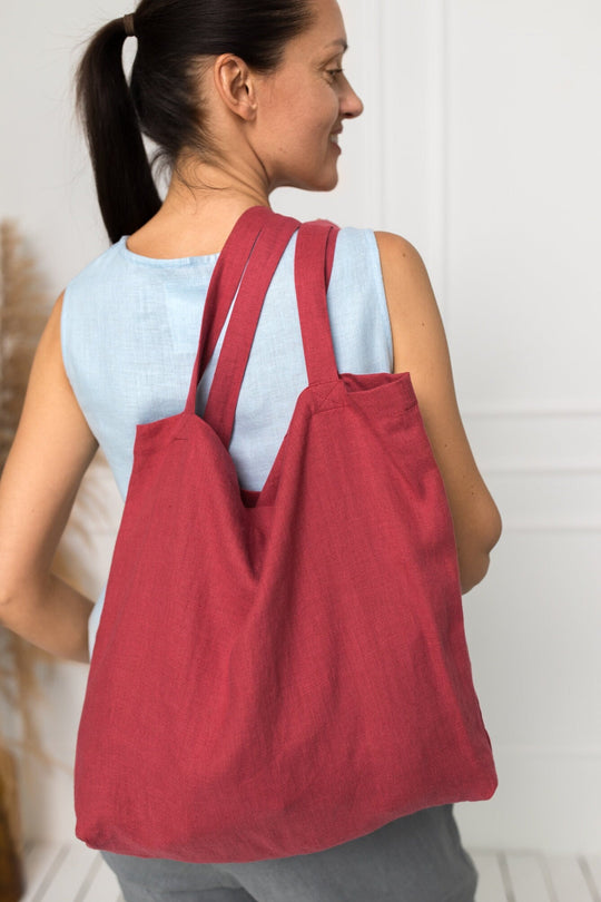 Model Demonstrates Daily Linen Tote Bag In Raspberry Color 1