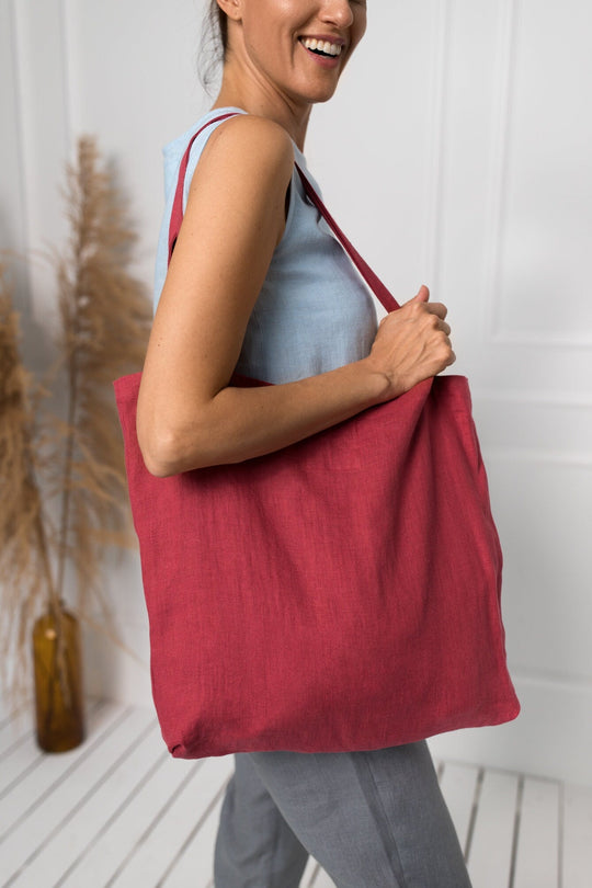 Model Demonstrates Daily Linen Tote Bag In Raspberry Color 2