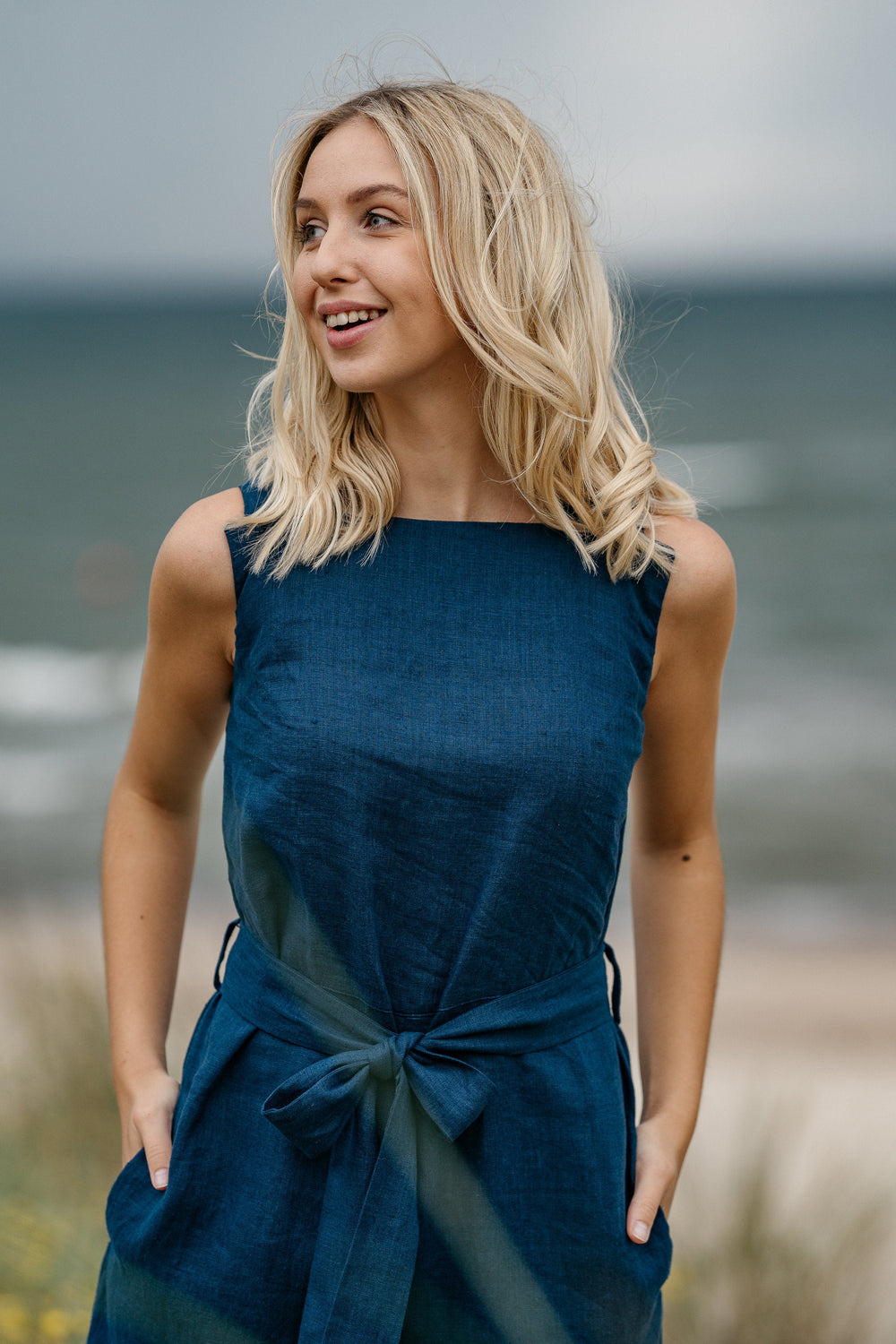 Model In Beach Demonstrates Linen Wrap Junpsuit Dicey In Midnight Blue Color 1 - Daily Linen