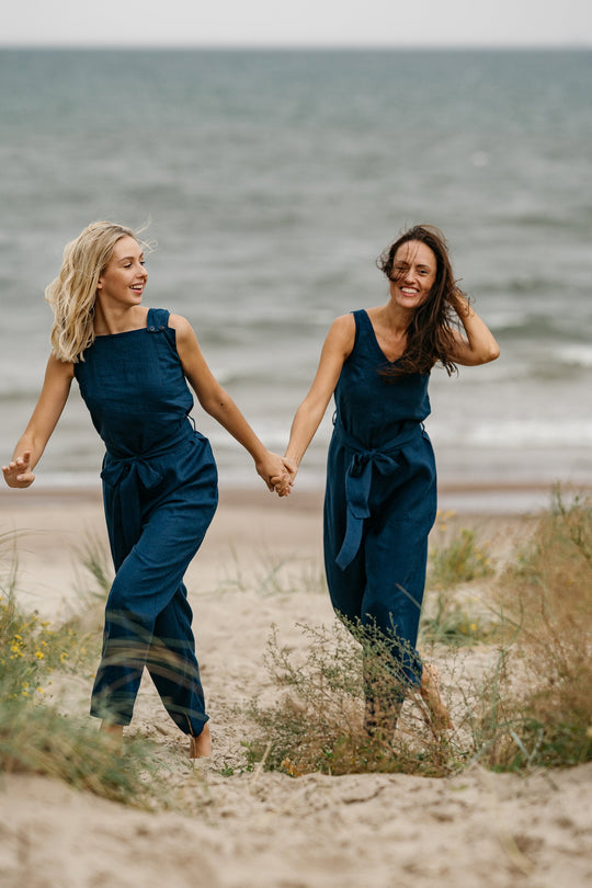 Models In Beach Demonstrates Linen Wrap Junpsuit Dicey In Midnight Blue Color 4 - Daily Linen