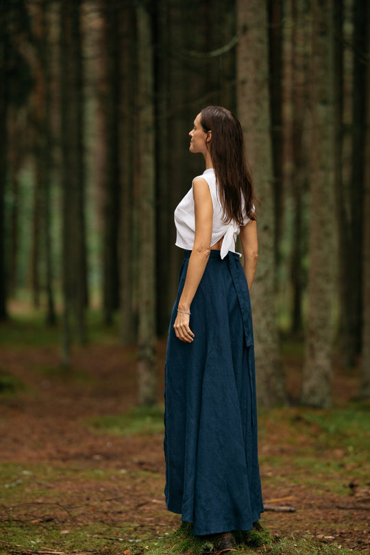 Model In Forest Wears Linen Wrap Maxi Skirt In Midnight Blue Color 3 - Daily Linen